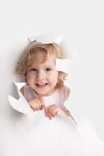 Child peeking through paper